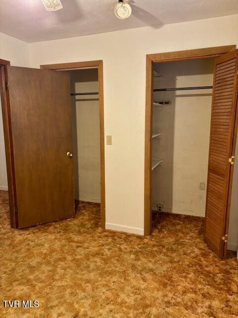 unfurnished bedroom featuring carpet floors and a ceiling fan