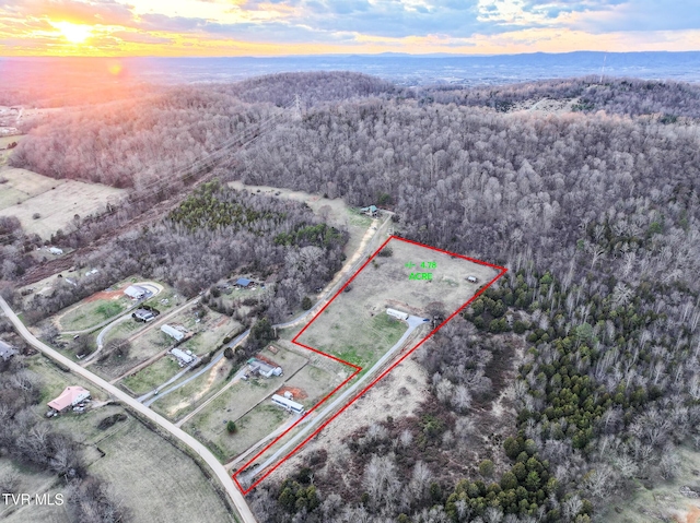 drone / aerial view featuring a wooded view