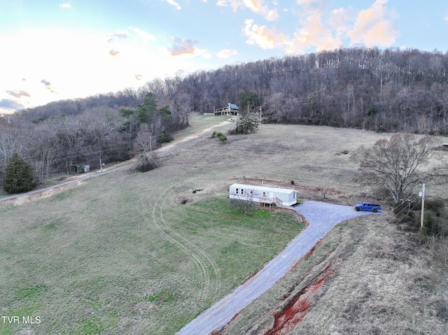 bird's eye view featuring a rural view and a wooded view