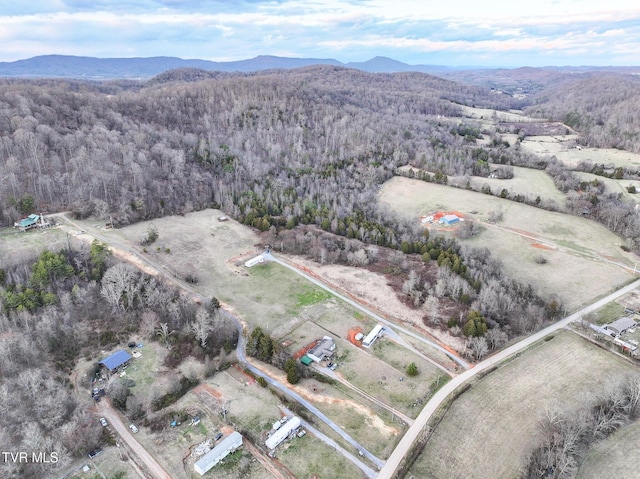 drone / aerial view with a mountain view and a forest view