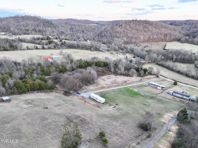 drone / aerial view featuring a wooded view