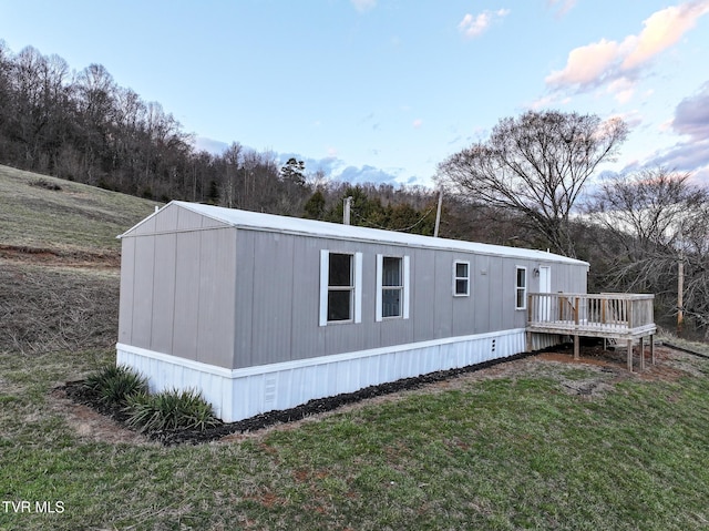 exterior space with a lawn and a wooden deck