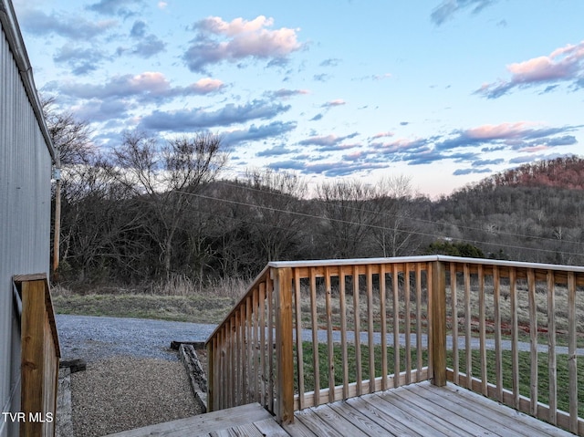 wooden terrace with a wooded view