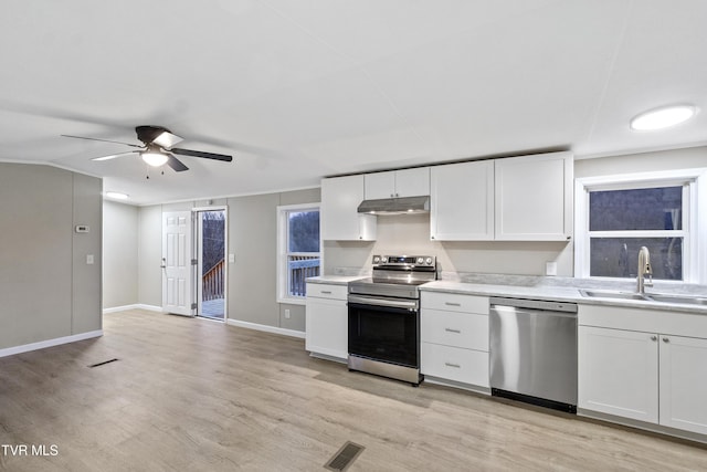 kitchen with visible vents, a sink, light countertops, under cabinet range hood, and appliances with stainless steel finishes