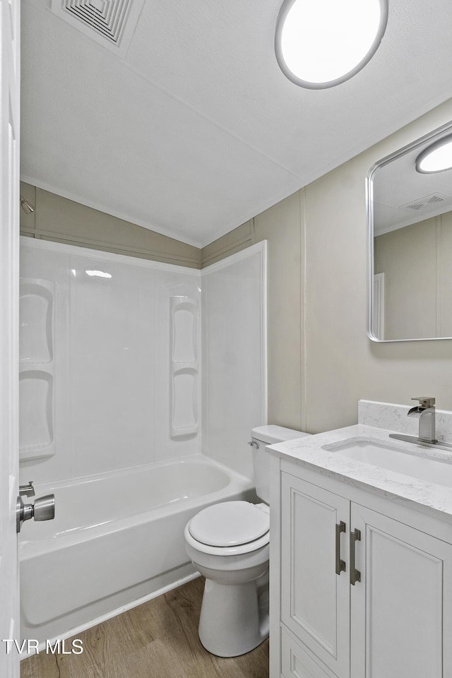 full bathroom featuring vanity, toilet, wood finished floors, and visible vents