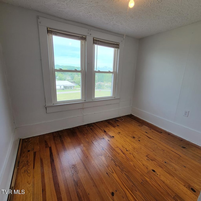 204 Highland Ave, Glade Spring, VA 24340 - spare room with a textured ceiling and hardwood / wood-style floors
