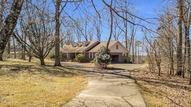 view of front of property featuring brick siding and driveway