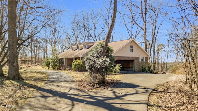 view of front of home with brick siding and driveway