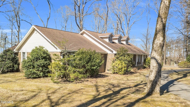 view of side of home with brick siding