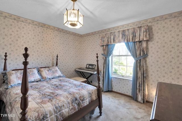 carpeted bedroom with wallpapered walls, baseboards, and a textured ceiling