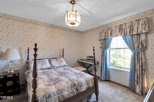 carpeted bedroom with wallpapered walls, baseboards, and a textured ceiling