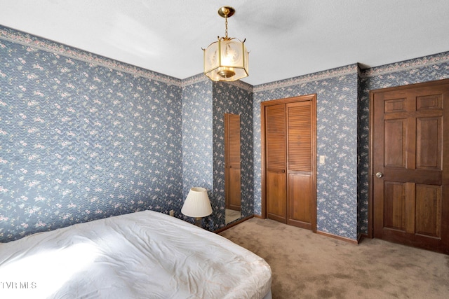 bedroom featuring baseboards, carpet, and wallpapered walls