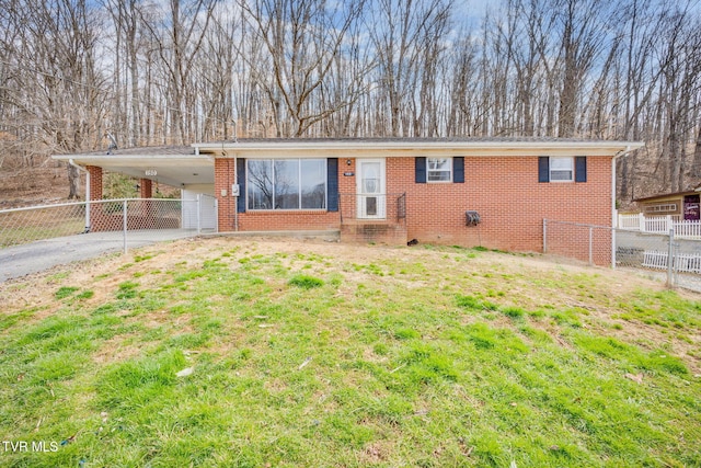 ranch-style home featuring an attached carport, a front yard, fence, aphalt driveway, and brick siding