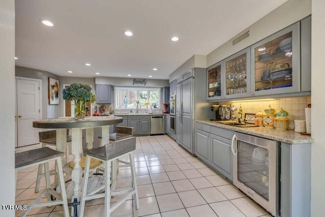 kitchen with visible vents, gray cabinets, tasteful backsplash, wine cooler, and dishwasher