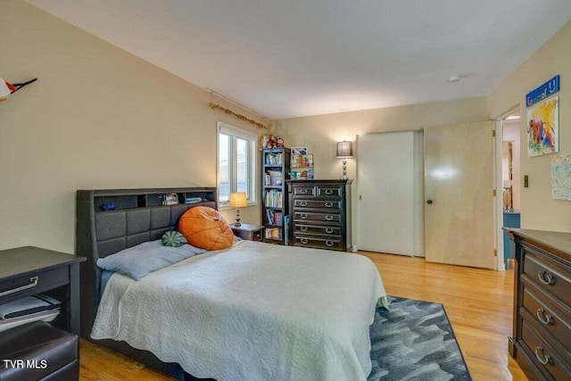 bedroom featuring a closet and light wood-style floors