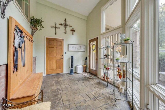 interior space featuring a high ceiling and stone finish flooring