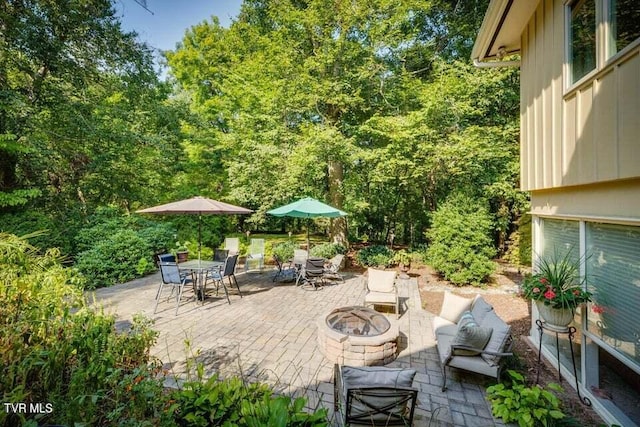 view of patio / terrace featuring outdoor dining space and a fire pit