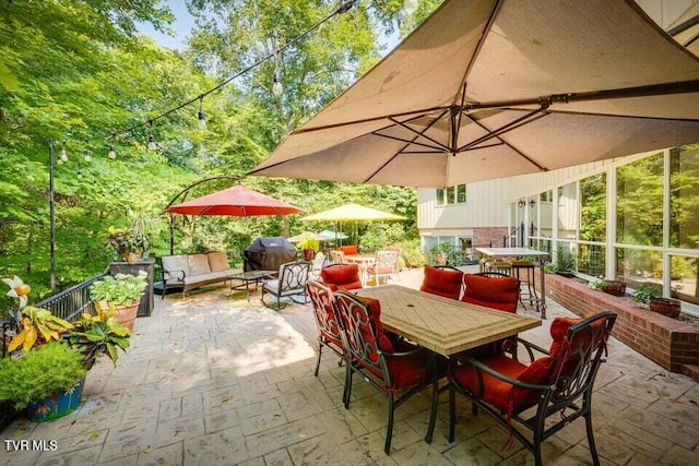 view of patio / terrace featuring outdoor dining space, a grill, and an outdoor hangout area