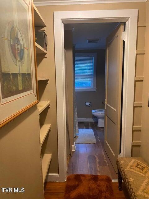 bathroom featuring visible vents, toilet, baseboards, and wood finished floors