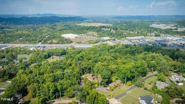 drone / aerial view with a wooded view