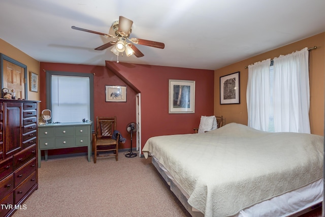 bedroom featuring baseboards, a ceiling fan, and light colored carpet