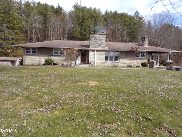 view of front of property with a front yard, stone siding, and a chimney