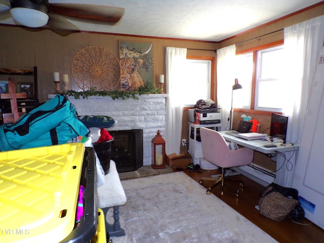 home office with wooden walls and wood finished floors