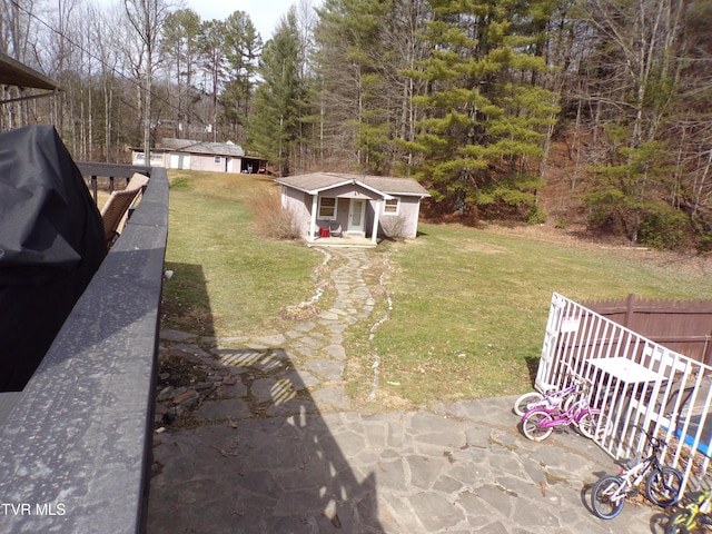 view of yard with an outdoor structure and fence