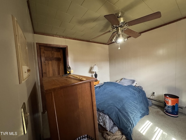 bedroom with a baseboard radiator, a ceiling fan, and crown molding