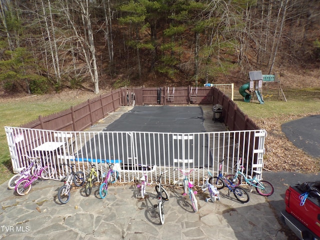 view of yard with a playground and a fenced backyard