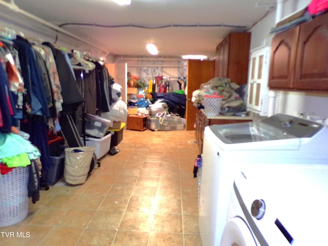 below grade area with light tile patterned floors and washing machine and clothes dryer