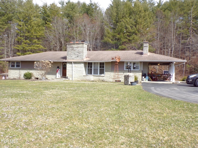 ranch-style home featuring stone siding, an attached carport, a chimney, and a front yard