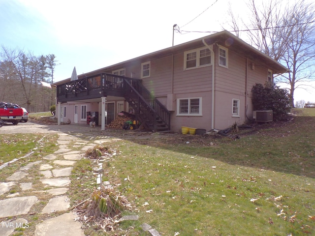 back of house with stairs, a deck, a yard, and central AC unit