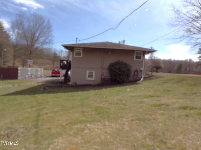 view of property exterior with a lawn