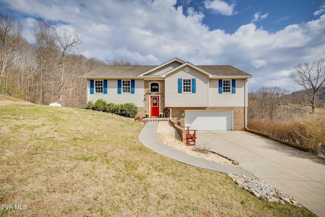 bi-level home featuring a garage, brick siding, concrete driveway, and a front lawn