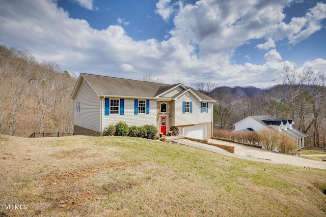 view of front of property with a front yard, a garage, and driveway