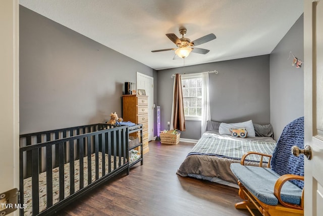 bedroom featuring ceiling fan, baseboards, and wood finished floors