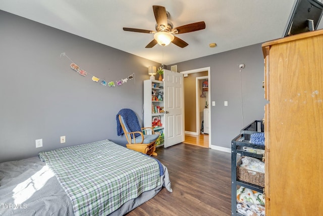 bedroom with ceiling fan, baseboards, and wood finished floors