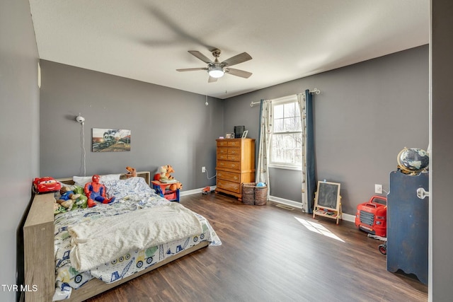 bedroom featuring ceiling fan, baseboards, and wood finished floors