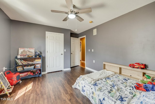 bedroom with visible vents, baseboards, wood finished floors, and a ceiling fan