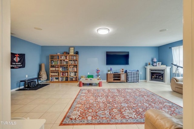 living area with tile patterned flooring, a fireplace, and baseboards