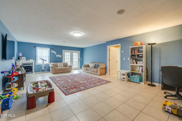 living area featuring tile patterned flooring, a fireplace, baseboards, and french doors