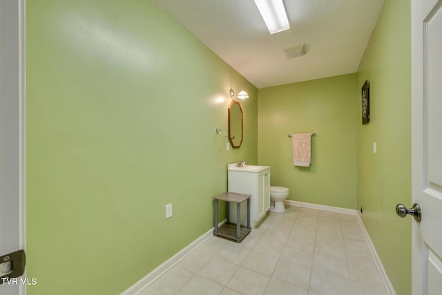 bathroom with tile patterned flooring, toilet, vanity, and baseboards