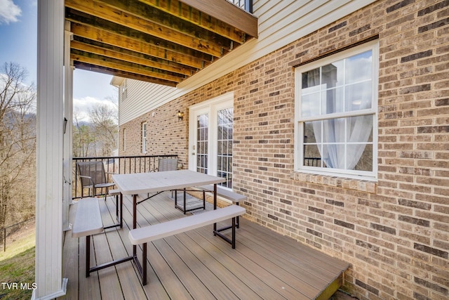 wooden deck featuring outdoor dining area