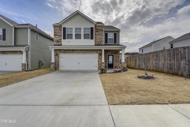 craftsman-style house featuring a front lawn, driveway, fence, an attached garage, and brick siding