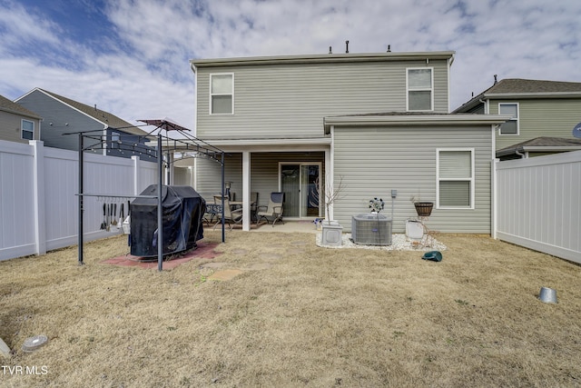 back of property featuring a patio, central AC unit, and a fenced backyard