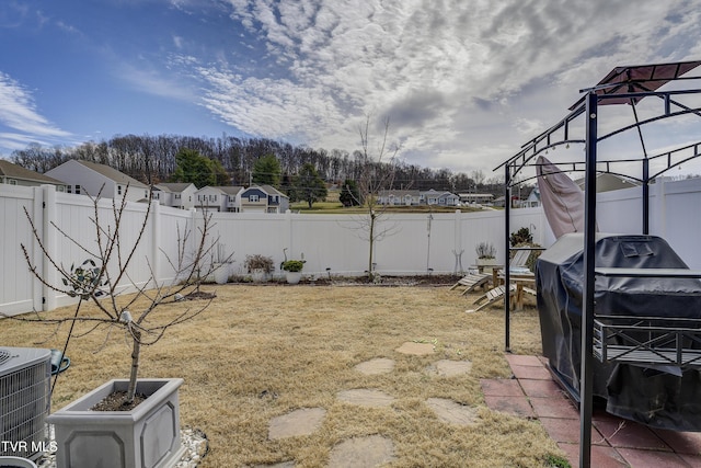 view of yard featuring central air condition unit and a fenced backyard