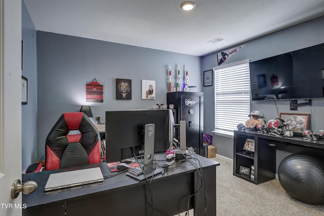 carpeted home office with baseboards and visible vents