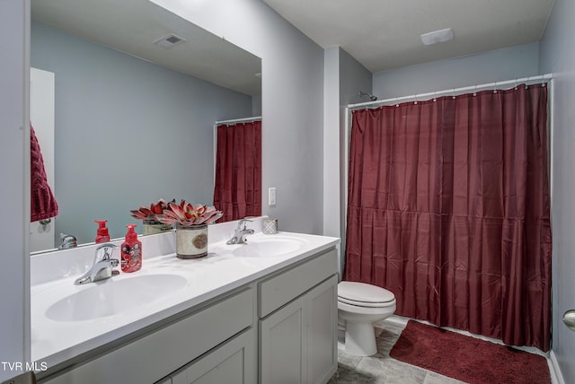 full bath featuring double vanity, toilet, visible vents, and a sink