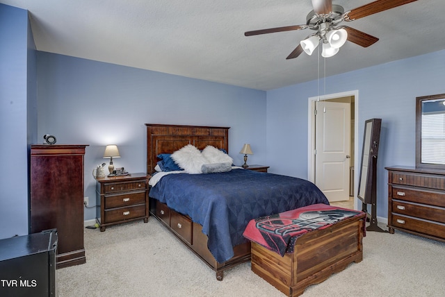 bedroom featuring baseboards, light carpet, and a ceiling fan